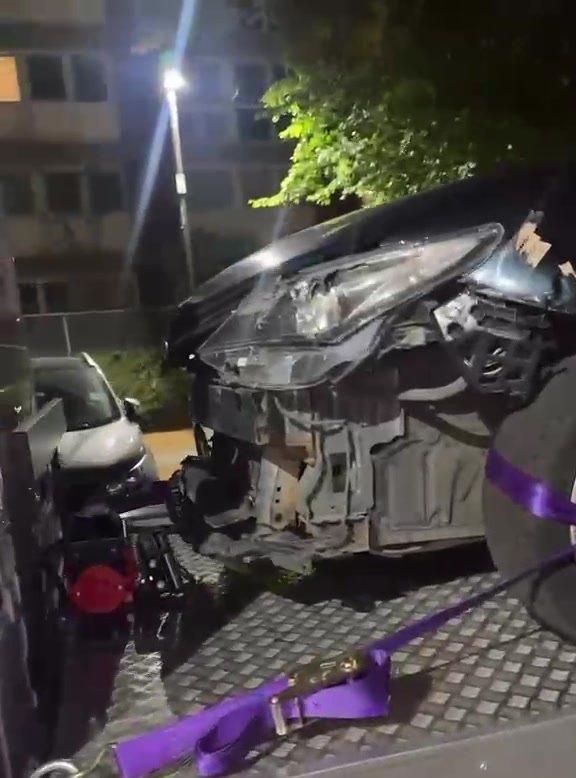 An accident-damaged car winched onto the MPG Recovery bed at night in East London