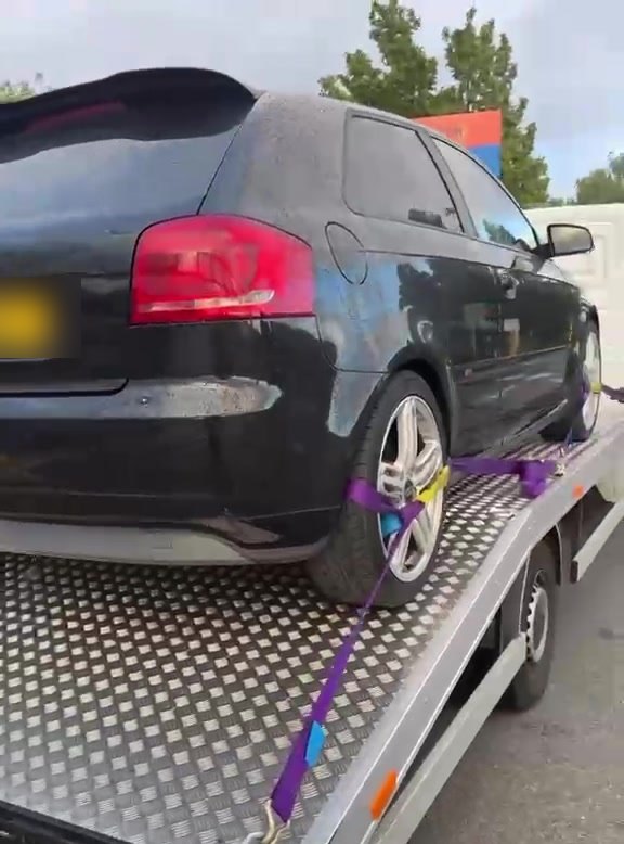 A car secured on the MPG Recovery bed at a London retail park