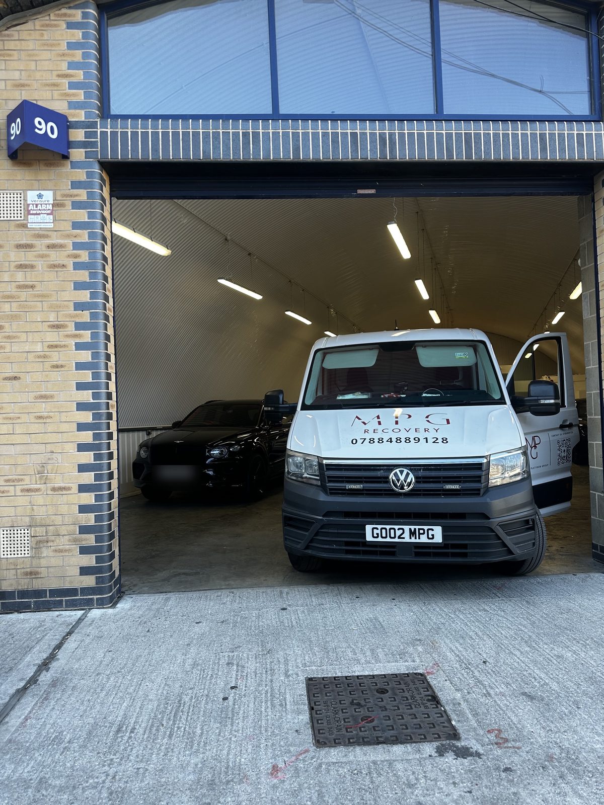 The MPG Recovery van inside the lit railway arch workshop in E1